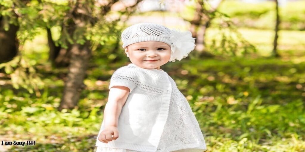 a child in a white dress and hat